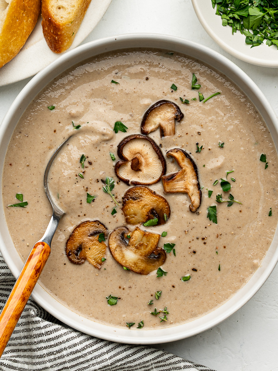 A close-up of a crisp salad containing radicchio, arugula, and shaved fennel, drizzled with a glistening vinaigrette, served 