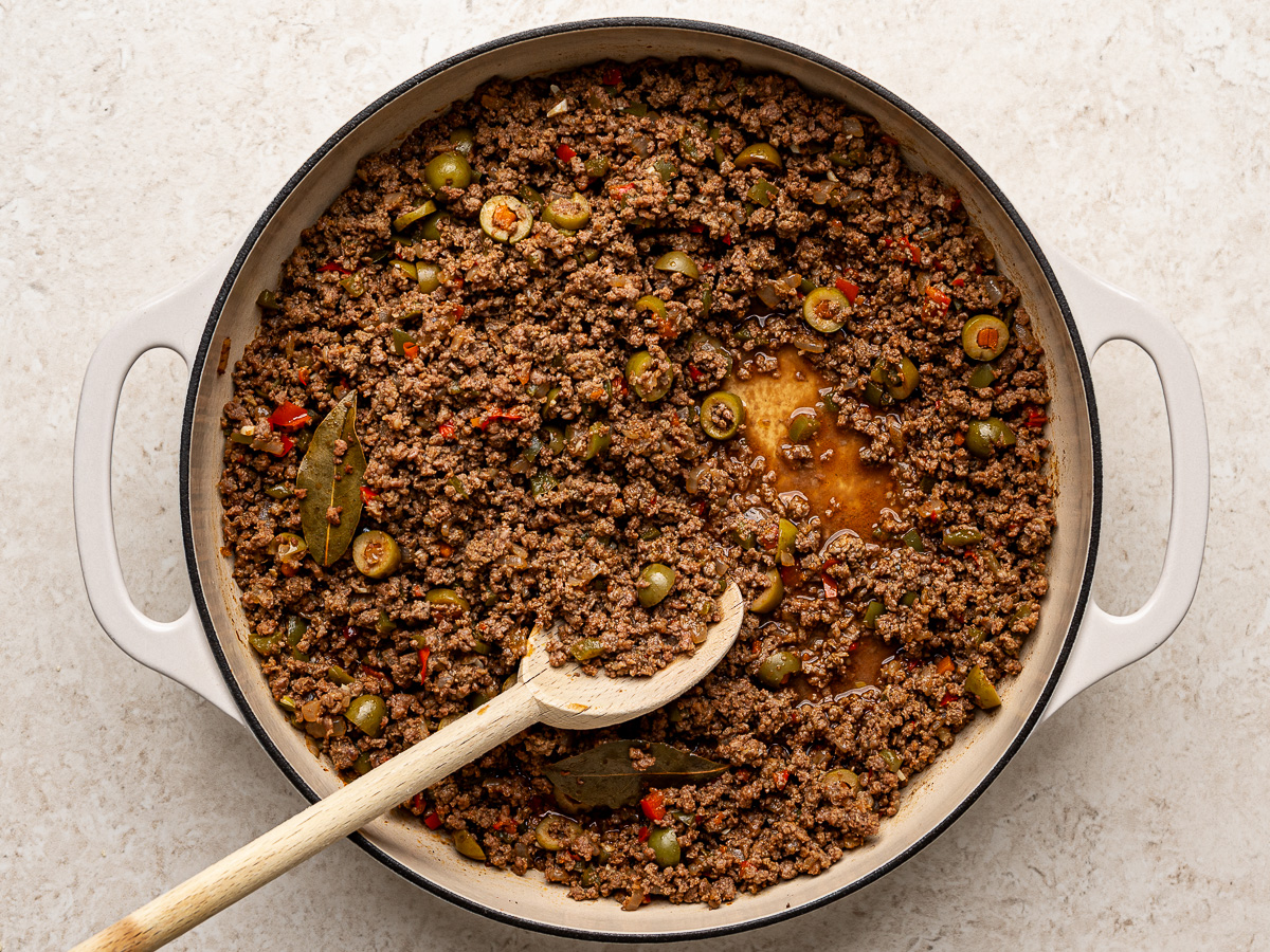 Cooked empanada ground beef filling in skillet.