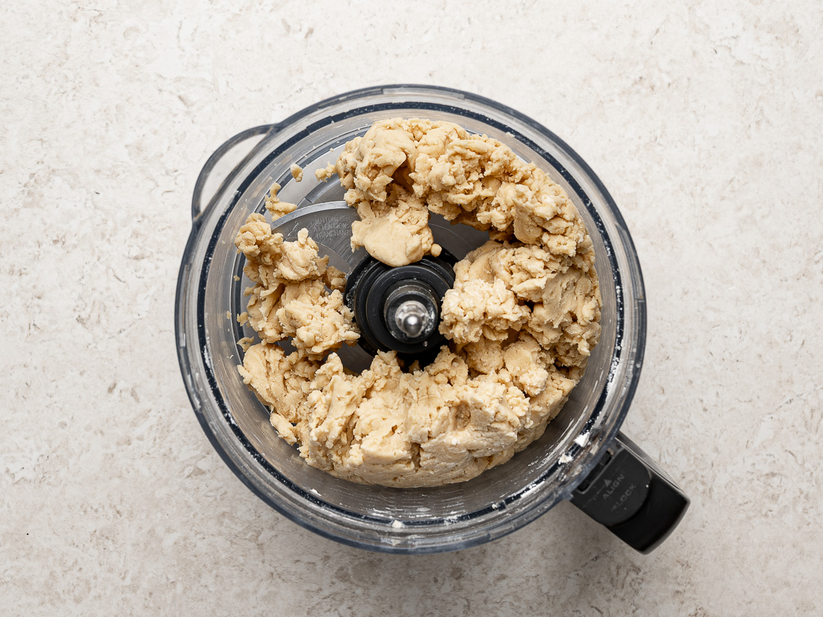 Empanada dough mixed in food processor.