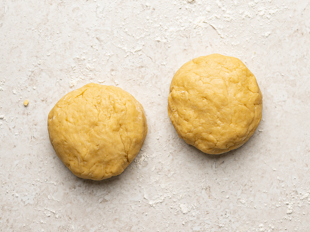 Two balls of empanada dough ready to rest before rolling.