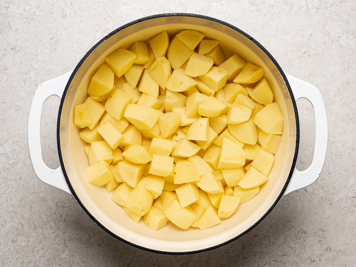 Chopped potatoes in large pot with water.