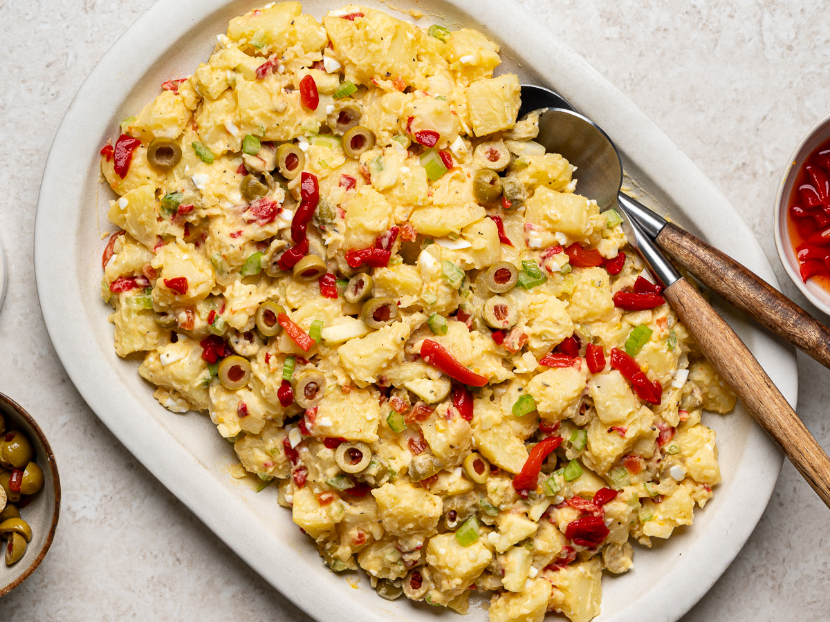 Puerto Rican potato salad on a creamy, oval serving platter.