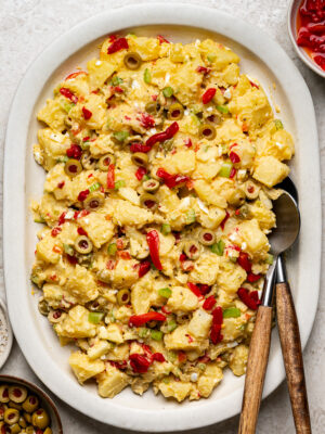 Puerto Rican potato salad on a creamy, oval serving platter.