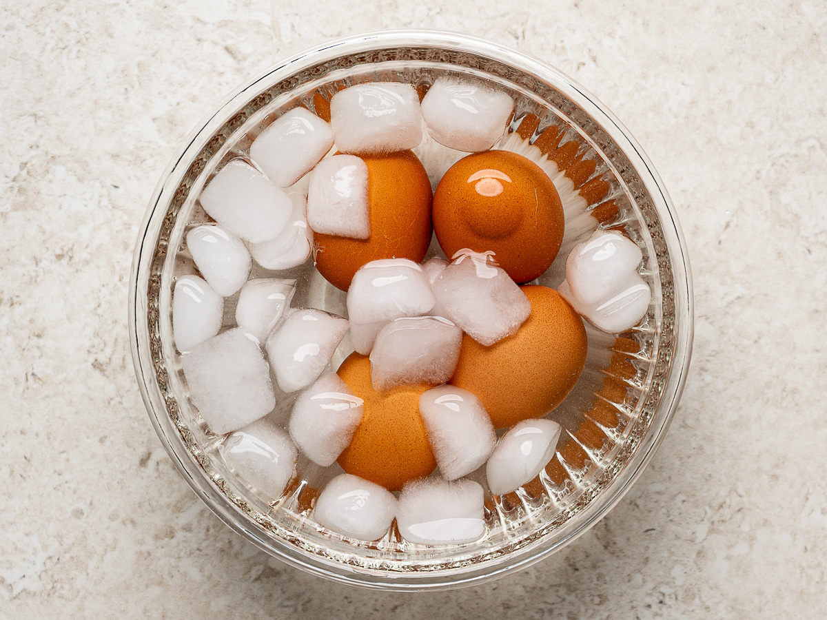 Hard-boiled eggs in a bowl of ice water.