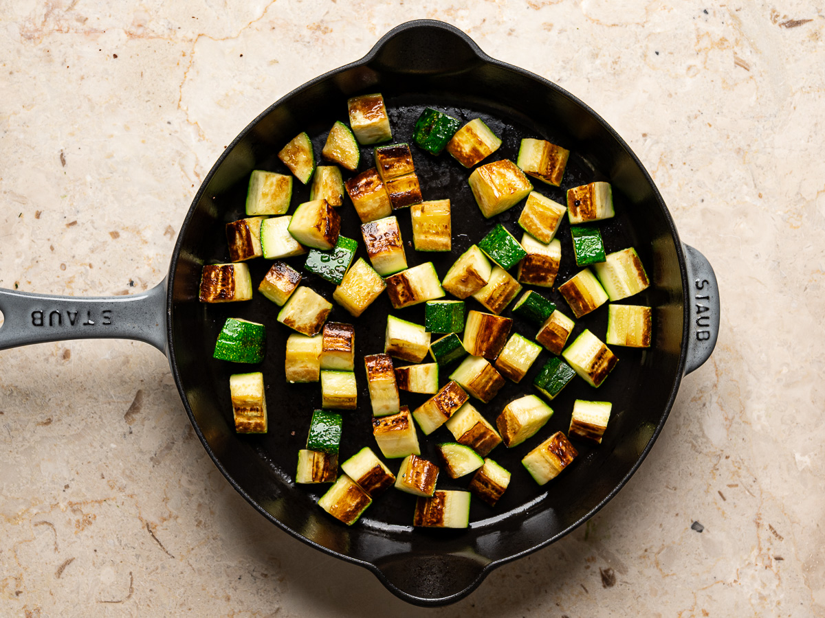 Zucchini pieces browned in skillet.
