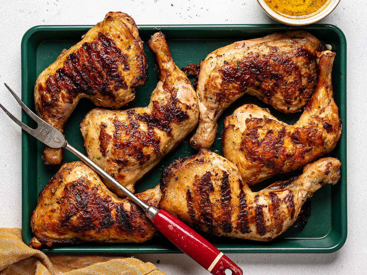 Grilled chicken legs on sheet pan.